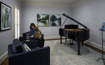 The Eisenberg piano room is painted in  Sherwin Williams North Star and has a rug reminiscent of piano keys. Goldendoodle Lexi has found herself a fine home // All photos by Howard Mendel