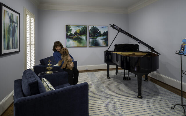 The Eisenberg piano room is painted in  Sherwin Williams North Star and has a rug reminiscent of piano keys. Goldendoodle Lexi has found herself a fine home // All photos by Howard Mendel