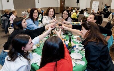 A table of seder attendees enjoy a toast for the holiday.