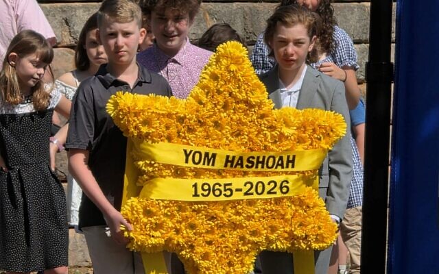 The fourth generation, the great-grandchildren of Holocaust survivors, carry a wreath in the shape of a Jewish star. The fourth generation, the great-grandchildren of Holocaust survivors, carry a wreath in the shape of a Jewish star.