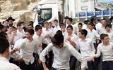 Some 20,000 celebrants packed the Tomb of Shimon haTzadik creating a carnival-like atmosphere with candy floss and hora circle dancing.