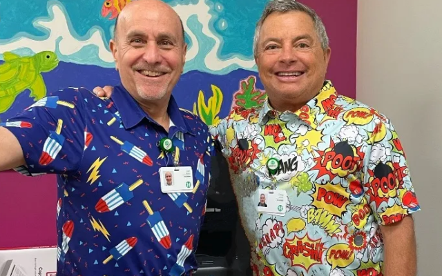 Joel Marks (left) and Craig Lefkoff have a complete wardrobe of brightly colored shirts for their volunteer work with children.