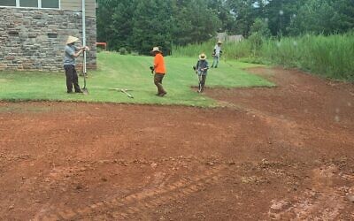 Contractors are pictured working on a grading project.