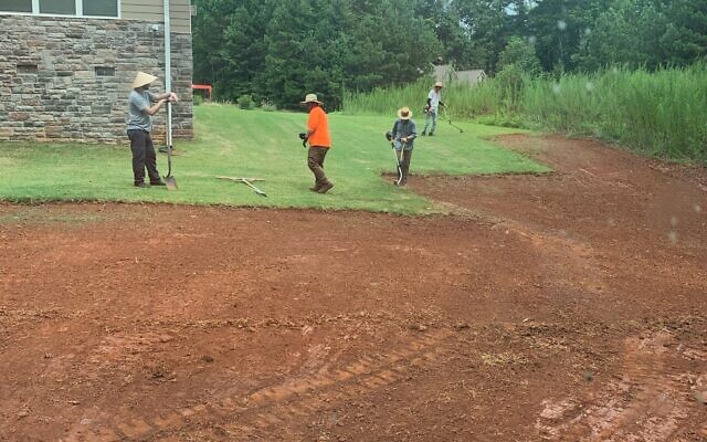 Contractors are pictured working on a grading project.