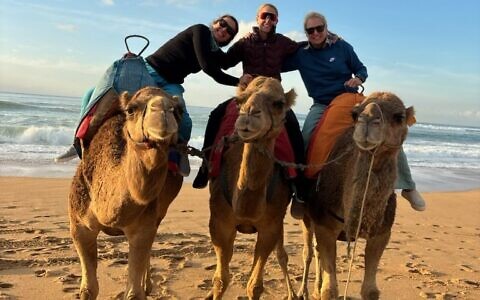 The travelers took a break from hiking with a camel ride on the beach in Tangiers.