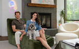 Laura and Philippe enjoy blue merle, mini golden doodle, Peppa. Above the fireplace is a near-abstract expressionist painting of koi in pastel hues by Cuban artist, Eric Alfaro // Photos by Howard Mendel