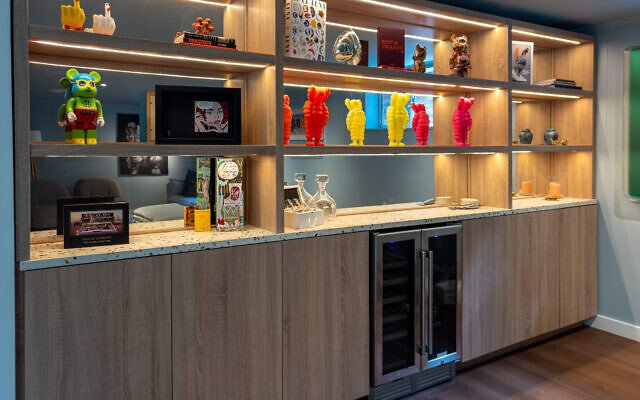 This glowing shelving on the front side of the TV room is color drenched in Behr’s, “Urban Raincoat,” shade of blue.  