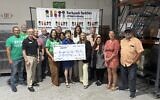 Backpack Buddies of Atlanta CB Cares 75k check presentation July 2026; Debbie Sonenshine pictured in the middle with check and Sherry Noles is to right of her.