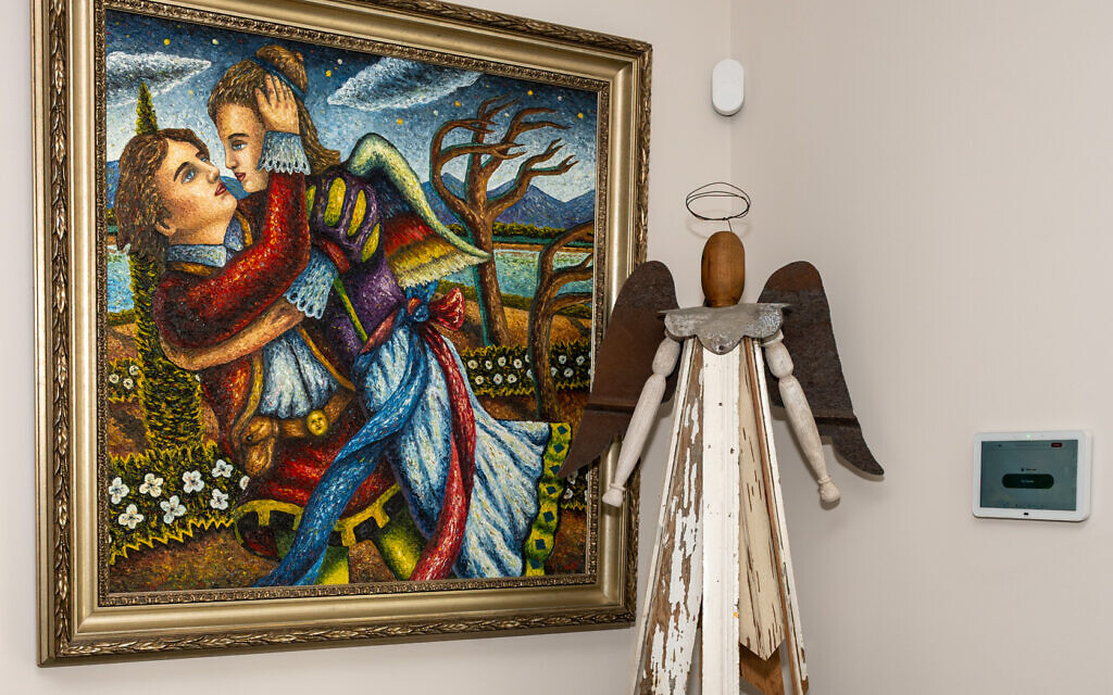 Lamar Smith’s provocative, “Capture,” is pictured alongside a wooden angel Gary found “retail” in Roswell.