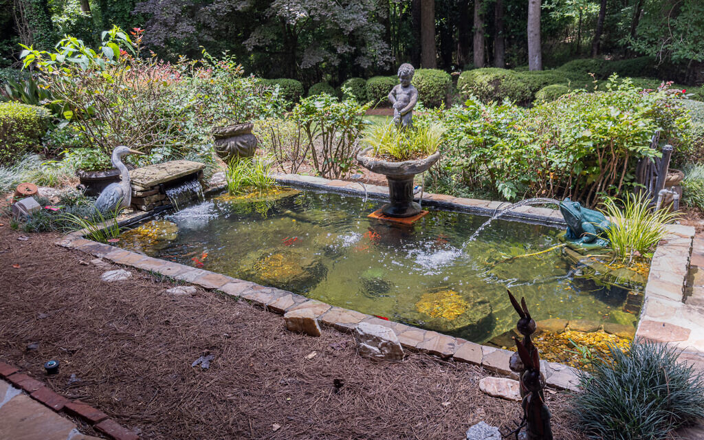 Judy’s front entrance welcomes with a koi pond and frog fountain.