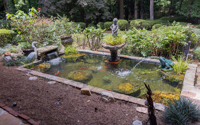 Judy’s front entrance welcomes with a koi pond and frog fountain.