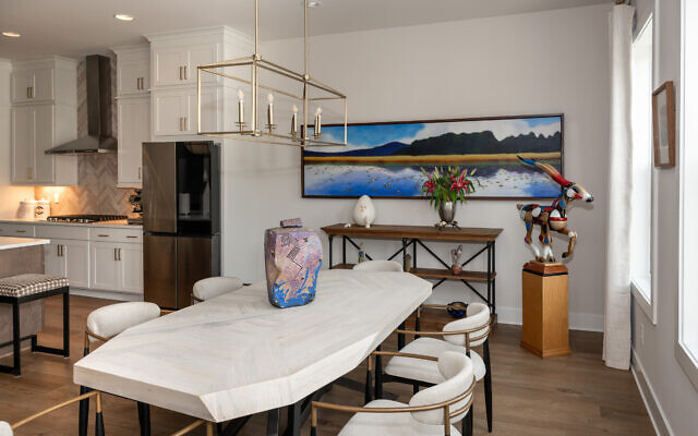 Gary’s dining area features Wolverine’s, “Moose,” with a strong sense of mood, scale and visual presence behind a wooden antelope by Dan Meyer.