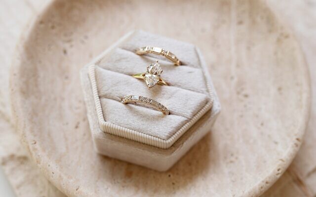 A custom marquise diamond engagement ring paired with coordinating bands reflects Brilliant’s approach to modern bridal jewelry. 