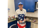 While volunteering and cooking more than 1,000 omelets, Al Finfer welcomes the USO at Hartsfield-Jackson Airport.