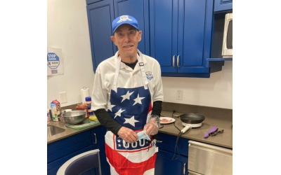 While volunteering and cooking more than 1,000 omelets, Al Finfer welcomes the USO at Hartsfield-Jackson Airport.
