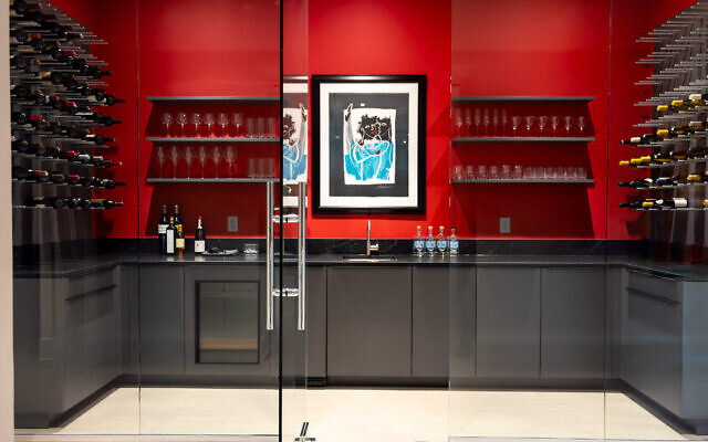 Gary designed the terrace level bar and wine room which features Poggenpohl cabinetry and appliances and a painting by disco star, Donna Summer.