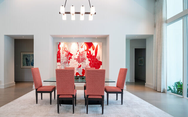 The Snyder dining room features the stunning scarlet Rocio Rodriguez painting.