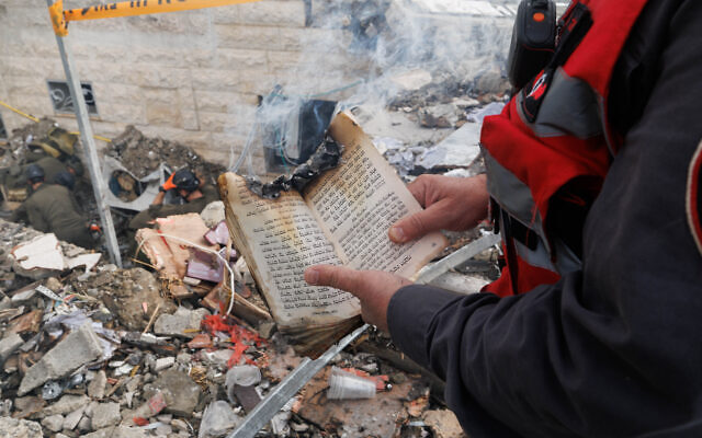 A missile from Iran hit a community in Beth Shemesh and a volunteer finds a Torah book partially burned.