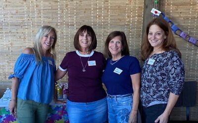 Four Hadassah ladies enjoying the sukkah: (from left) Mindy Cohen, Penny Pawliger, Amy Mittelberg, and Linda Goldman
