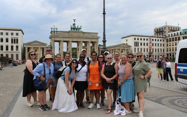 The teachers’ group is pictured in front of the Brandenburg Gate, one of the most iconic sights in Berlin.