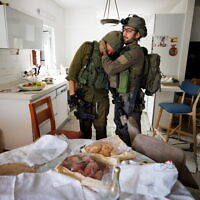 Reservist Yair Ansbacher can’t hold back tears in the sight of the holiday table for Simchat Torah // Photo Credit: Ziv Koren