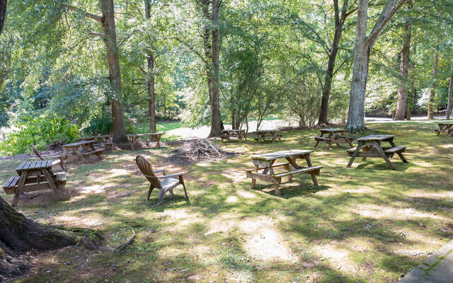 The backyard has on old red barn and plenty of space for fireside chats and mentoring young women. 
