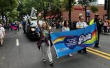Jewish Atlanta community members are pictured marching in the parade.