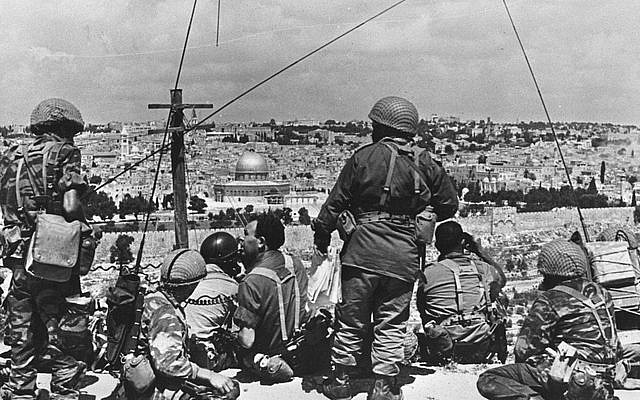 Mordechai Gur (seated, with black curly hair) and his troops survey the Old City before launching their attack, May 1967. (photo credit: Wikimedia Commons CC BY-SA/Mazel123)