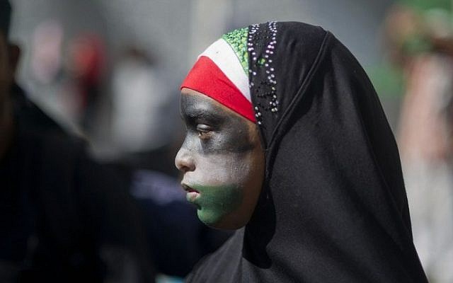Illustrative: A girl wearing a hijab and with her face painted in the colors of the Palestinian flag taking part in an anti-Israel march in South Africa, on August 9, 2014. (Roger Bosch/AFP)