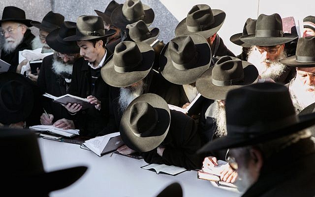 Chabad rabbis at the gravesite of the Lubavitcher Rebbe, in Queens, New York Friday, Nov. 21, 2014. (AP Photo/Chabad.org, Adam Ben Cohen)