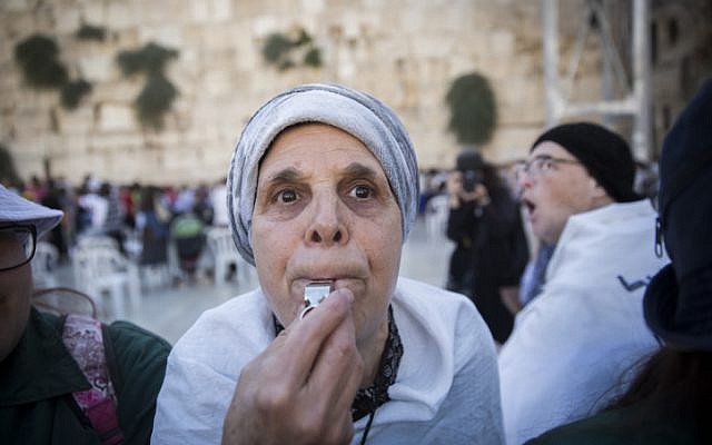 An ultra-Orthodox woman whistles in protest of the Women of the Wall group's Rosh Hodesh (New Jewish month) prayer at the Western Wall, in Jerusalem's Old City, on July 7, 2016 (Hadas Parush/Flash90)