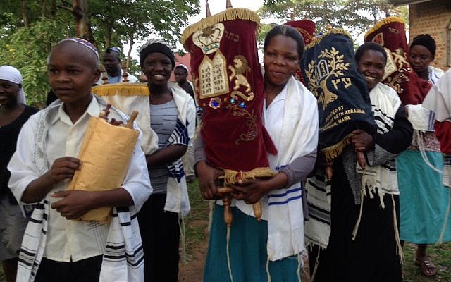 Ugandan Jews carrying Torah scrolls (Courtesy of Be’chol Lashon via JTA)