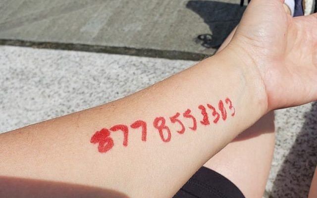 The ACLU legal aid's phone number, written on Shira Pruce's forearm with a red sharpie, June 28, 2018. (Courtesy, Shira Pruce).