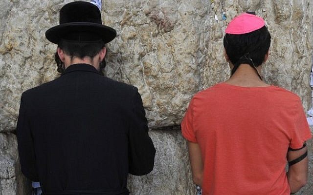 A Haredi and a secular Jew praying at the Western Wall in Jerusalem. (Serge Attal/Flash90)