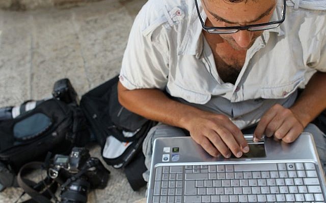 Man uses a laptop (Photo credit: Nati Shohat/Flash90)