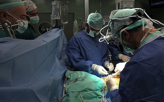 Illustrative. Doctors perform surgery on a patient at the Wolfson Medical Center in Holon. (Nati Shohat/Flash90)