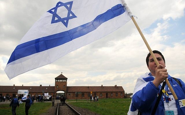An Israeli young woman waves the Israeli flag as she participates with hundreds of other Israeli youth in "the March of the Living" tour which involves visiting concentration and death camps in Poland. May 02, 2011. (photo credit: Yossi Zeliger/Flash90)