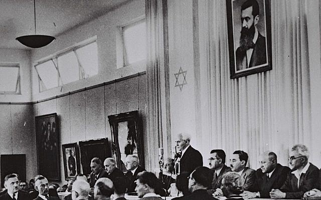 David Ben-Gurion, flanked by the members of his provisional government, reads the Declaration of Independence in the Tel Aviv Museum Hall on May 14, 1948 (Israel Government Press Office)