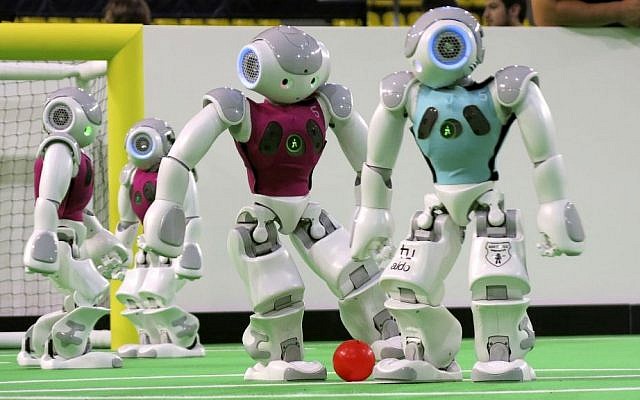 Robots in the 'standard platform' division compete at the RoboCup championships in Eindhoven, Netherlands, on June 27, 2013.  (photo credit: AP/Toby Sterling)