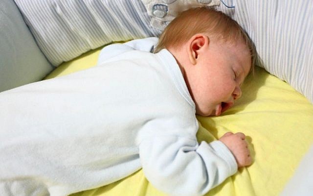 A baby seen sleeping in a cradle, illustrative photo (Photo credit: Chen Leopold/Flash90)