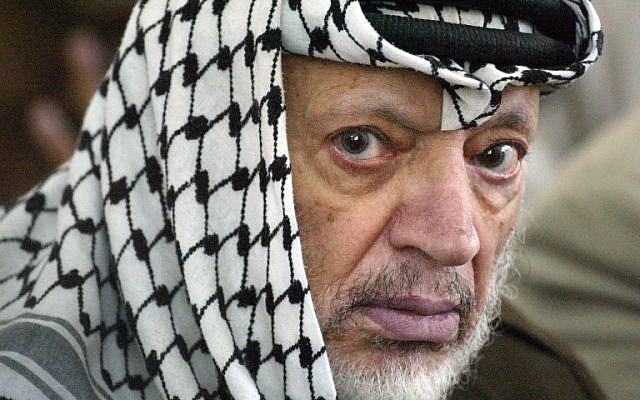 A file picture taken in the West Bank city of Ramallah on June 7, 2002, shows Palestinian leader Yasser Arafat attending Friday Muslim prayers. (photo credit: AFP PHOTO / Thomas COEX)
