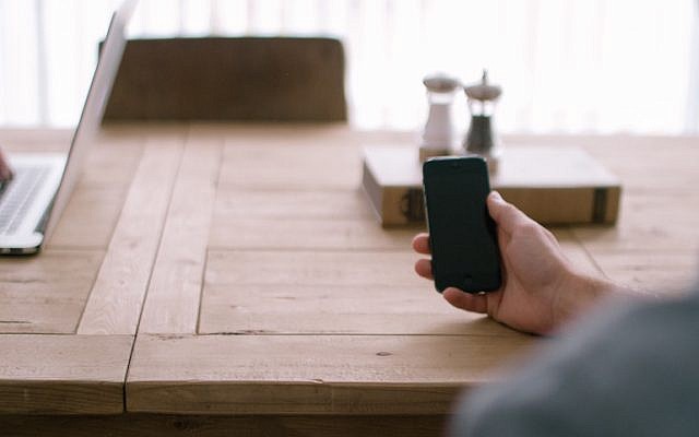 Users check their devices (Photo credit: Pexels)