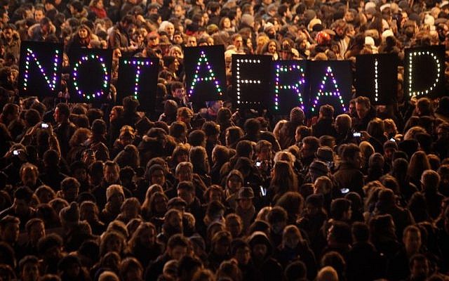 People gather in solidarity of the victims of a terror attack against a satirical newspaper, in Paris, Wednesday, Jan. 7, 2015. (Photo credit: AP/Thibault Camus)