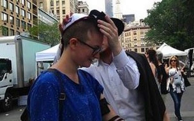 A Chabad representative lays tefillin on Baci Weiler in New York's Union Square on Friday, June 19, 2015 (Facebook)