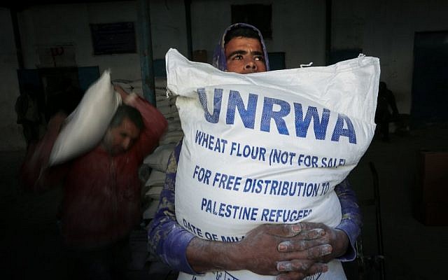 Palestinians receive their monthly food aid at a United Nations distribution center in the Rafah refugee camp, in southern Gaza Strip, February 8, 2015 (Abed Rahim Khatib/Flash90)