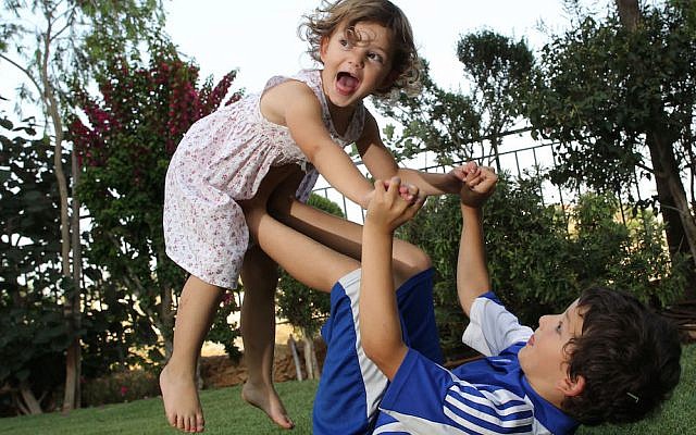 Israeli children play in a garden on a hot summer day. July, 2011. (Nati Shohat/FLASH90)