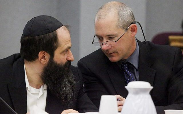 Defense attorney Montgomery Brown, right, and Sholom Rubashkin talk during the trial of Rubashkin, on state child labor charges on May 14, 2010, at the Black Hawk County Courthouse in Waterloo, Iowa. (Andrea Melendez/AP, Pool)