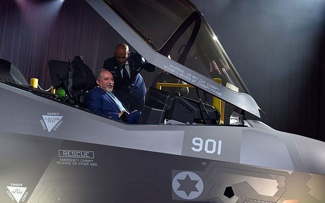 Defense Minister Avigdor Liberman sits in the cockpit of the F-35 stealth fighter jet, as IAF Chief of Staff Brig. Gen. Tal Kelman stands over him, during an unveiling ceremony in Fort Worth, Texas, on June 22, 2016. (Ariel Hermoni/Defense Ministry)