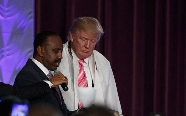 Donald Trump wears a tallit, or Jewish prayer shawl, as he's presented with a gift during a church service at Great Faith Ministries, Saturday, Sept. 3, 2016, in Detroit (Evan Vucci/AP)