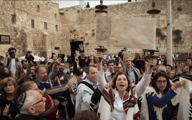 Anat Hoffman, director of Women of the Wall, holds a Torah scroll at the Western Wall, November 2, 2016. (Luke Tress/Times of Israel)